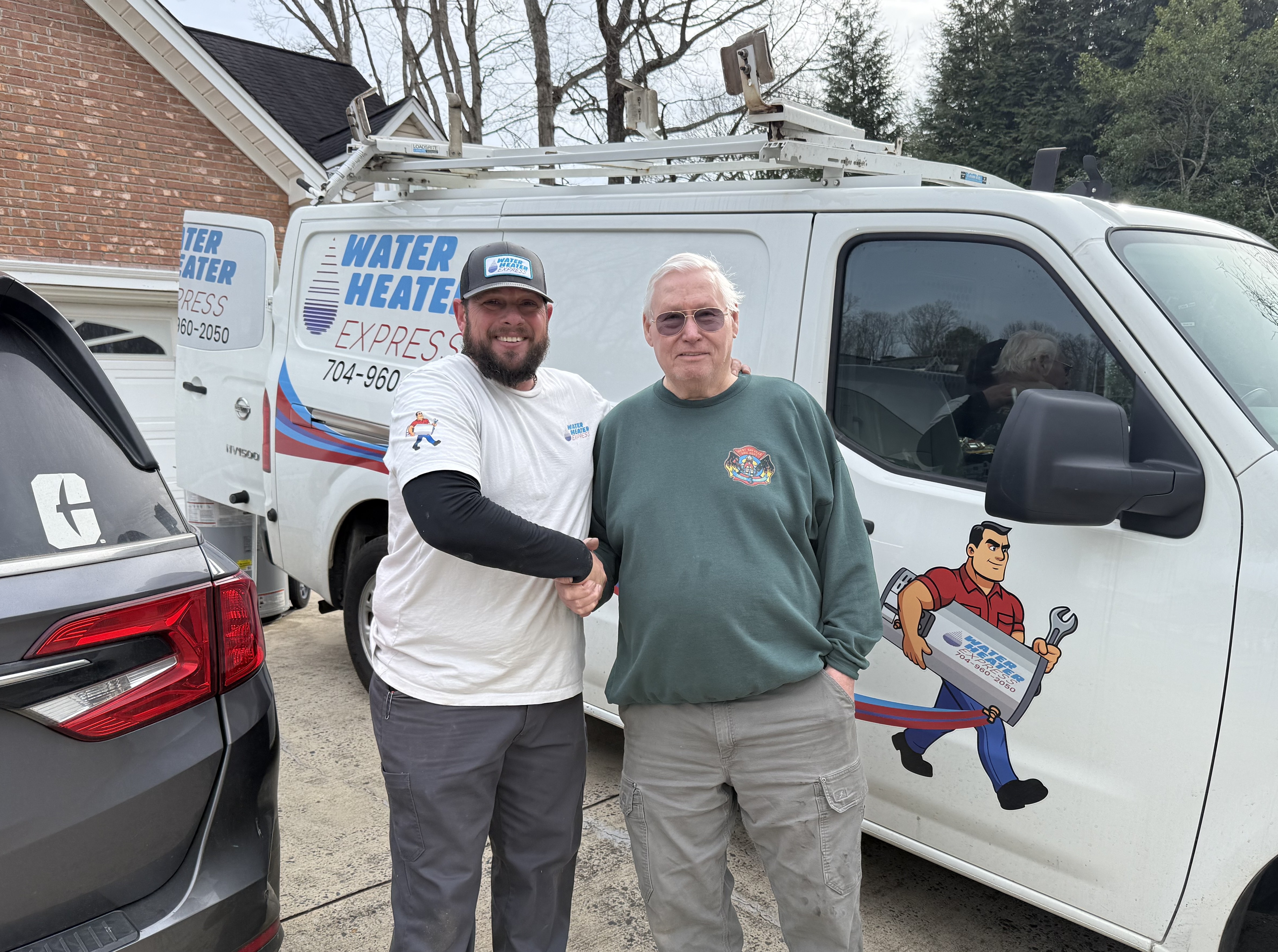 Water Heater Express technician with satisfied customer in Concord neighborhood